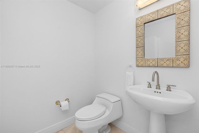 a bathroom with a toilet a sink and mirror