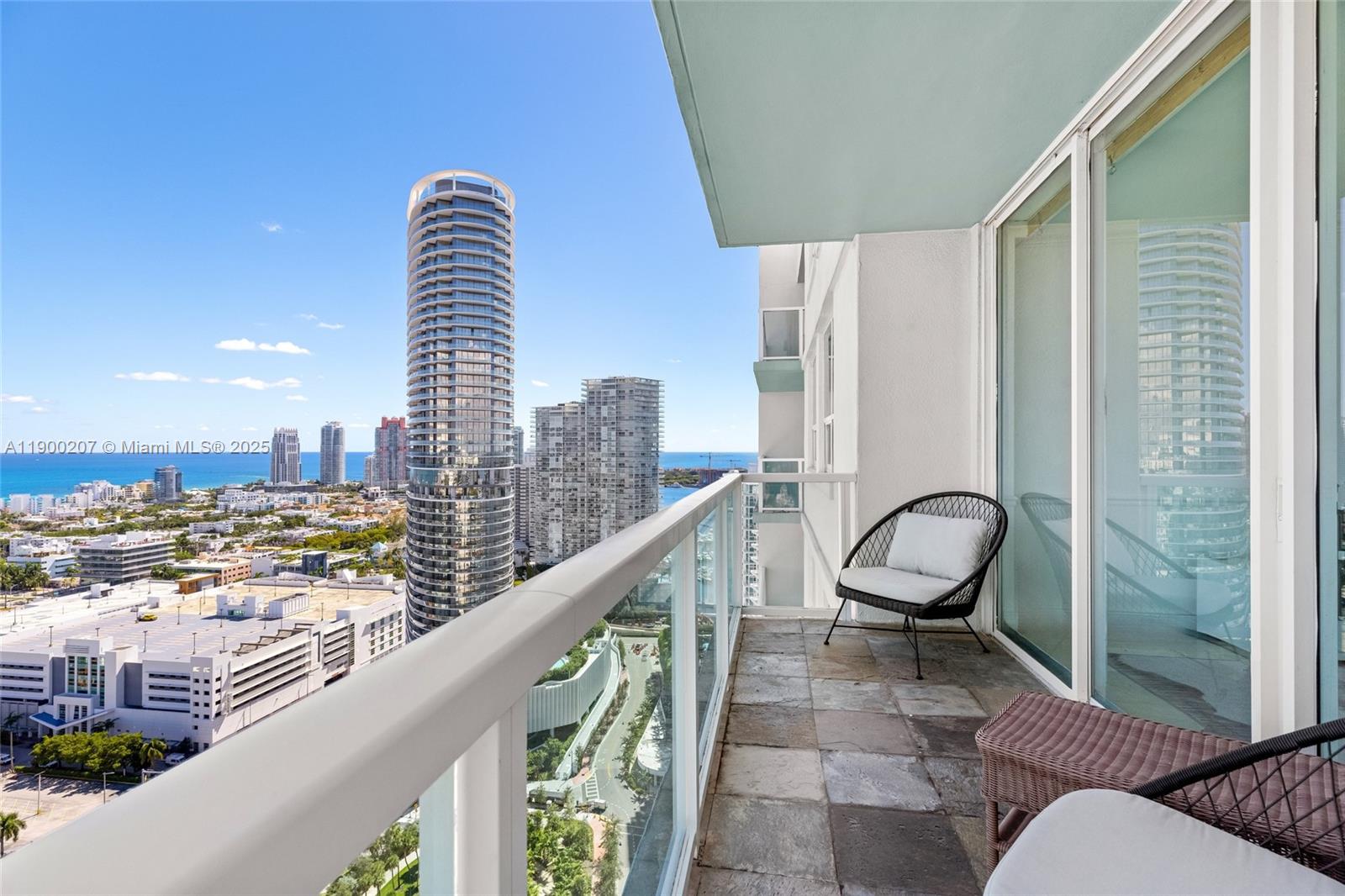 650 West Avenue, Unit PH12 Miami Beach, FL 33139 - Photo 28 of 37 a view of a balcony with an outdoor space and seating