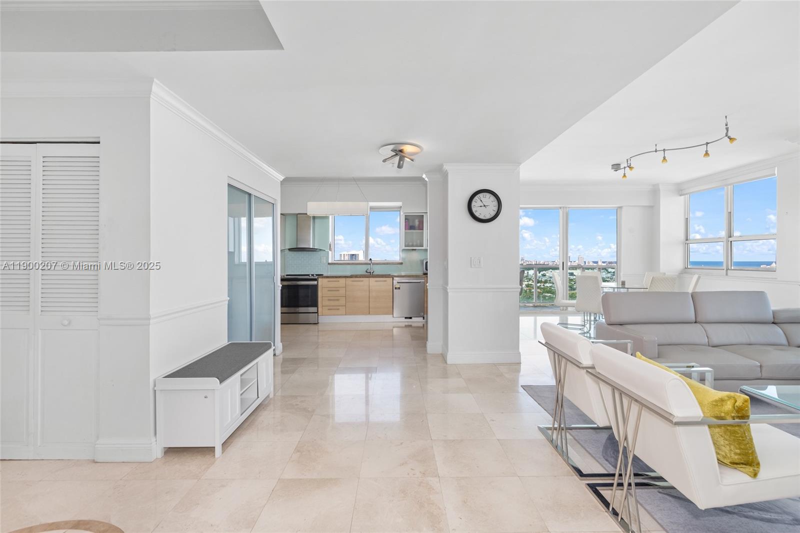 650 West Avenue, Unit PH12 Miami Beach, FL 33139 - Photo 4 of 37 a living room with stainless steel appliances kitchen island granite countertop furniture and a view of kitchen