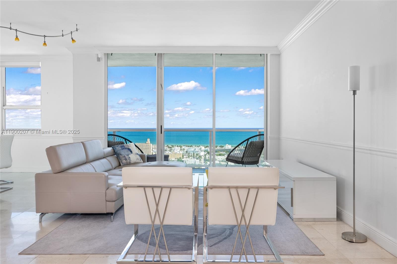 650 West Avenue, Unit PH12 Miami Beach, FL 33139 - Photo 5 of 37 a view of a livingroom with furniture and floor to ceiling window
