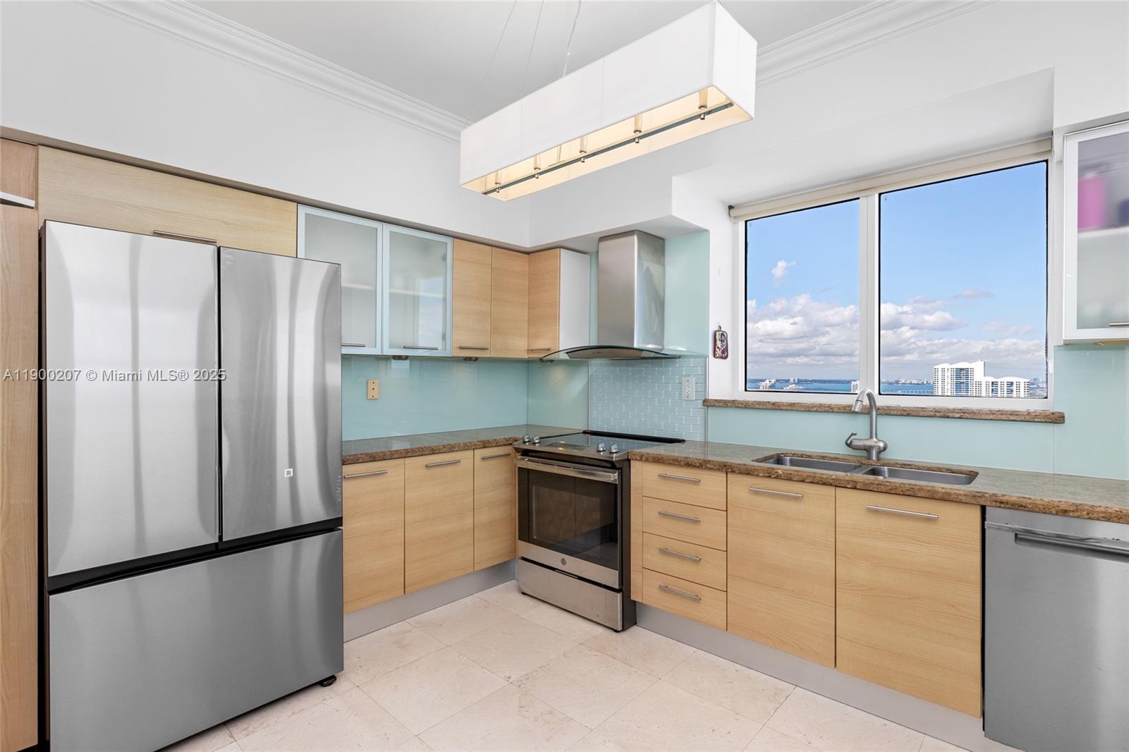 650 West Avenue, Unit PH12 Miami Beach, FL 33139 - Photo 9 of 37 a kitchen with stainless steel appliances granite countertop a refrigerator a sink a stove and white cabinets