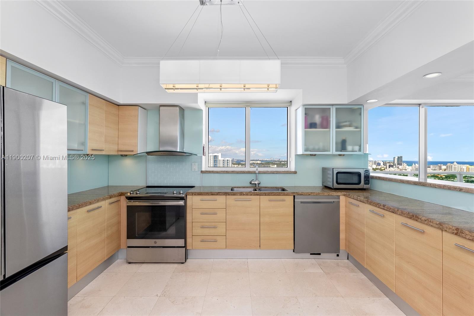 650 West Avenue, Unit PH12 Miami Beach, FL 33139 - Photo 10 of 37 a kitchen with a sink cabinets and stainless steel appliances