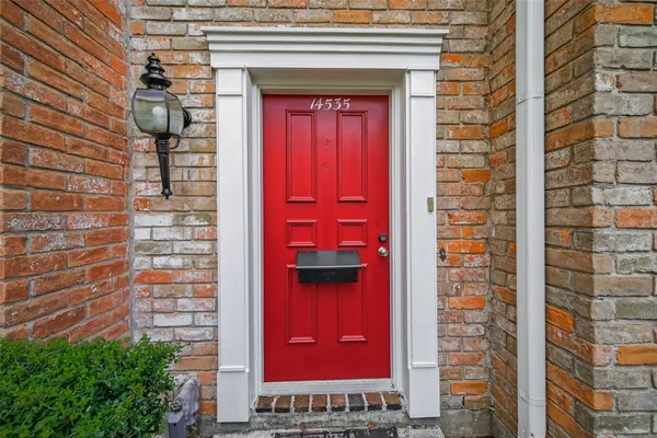 a front view of a building with a door and a shower