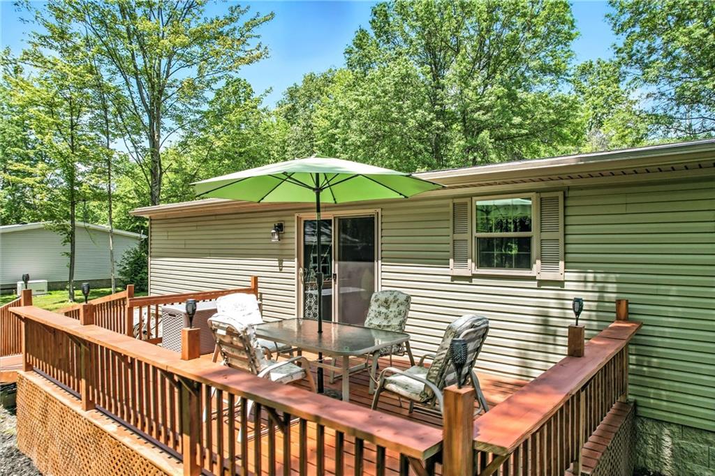 73 South Summit Road, Unit 503 Greenville, PA 16125 - Photo 30 of 36 a view of a patio with a table and chairs under an umbrella