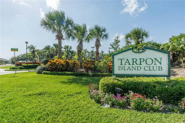 a sign that is sitting in front of flowers