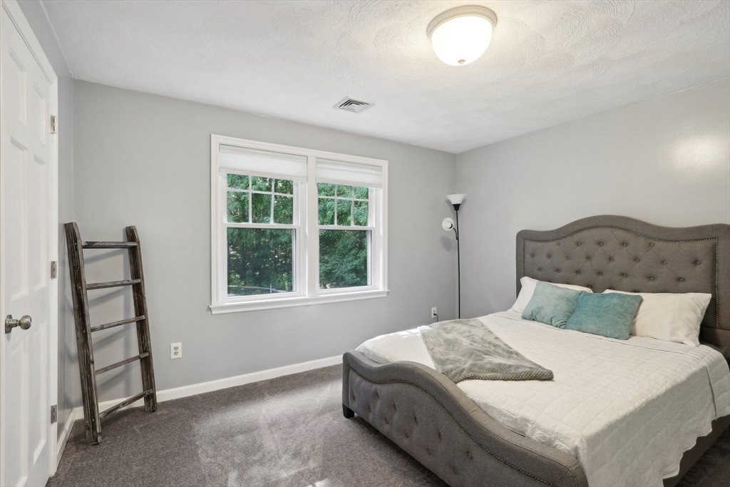 12 Spring Hill Road Merrimac, MA 01860 - Photo 26 of 42 a bedroom with a bed and a window