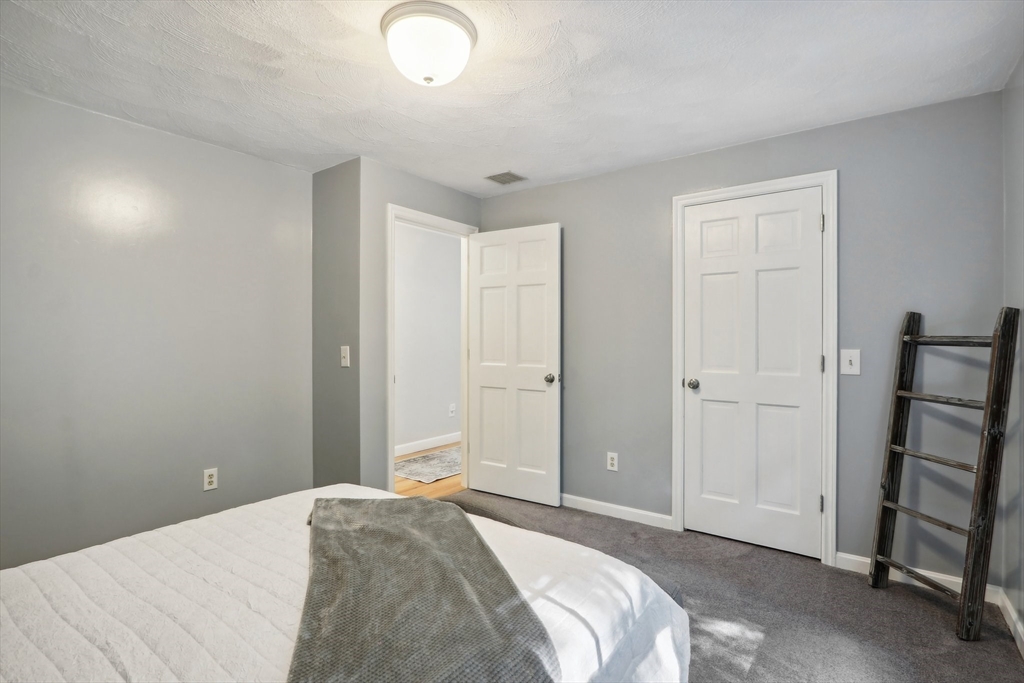 12 Spring Hill Road Merrimac, MA 01860 - Photo 27 of 42 a bedroom with a bed and a window