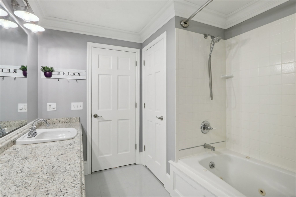 12 Spring Hill Road Merrimac, MA 01860 - Photo 31 of 42 a bathroom with a granite countertop sink a mirror a shower and a bathtub