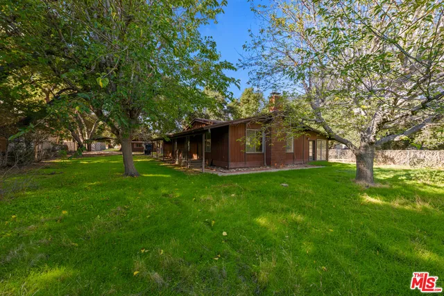 a view of outdoor space with deck and yard