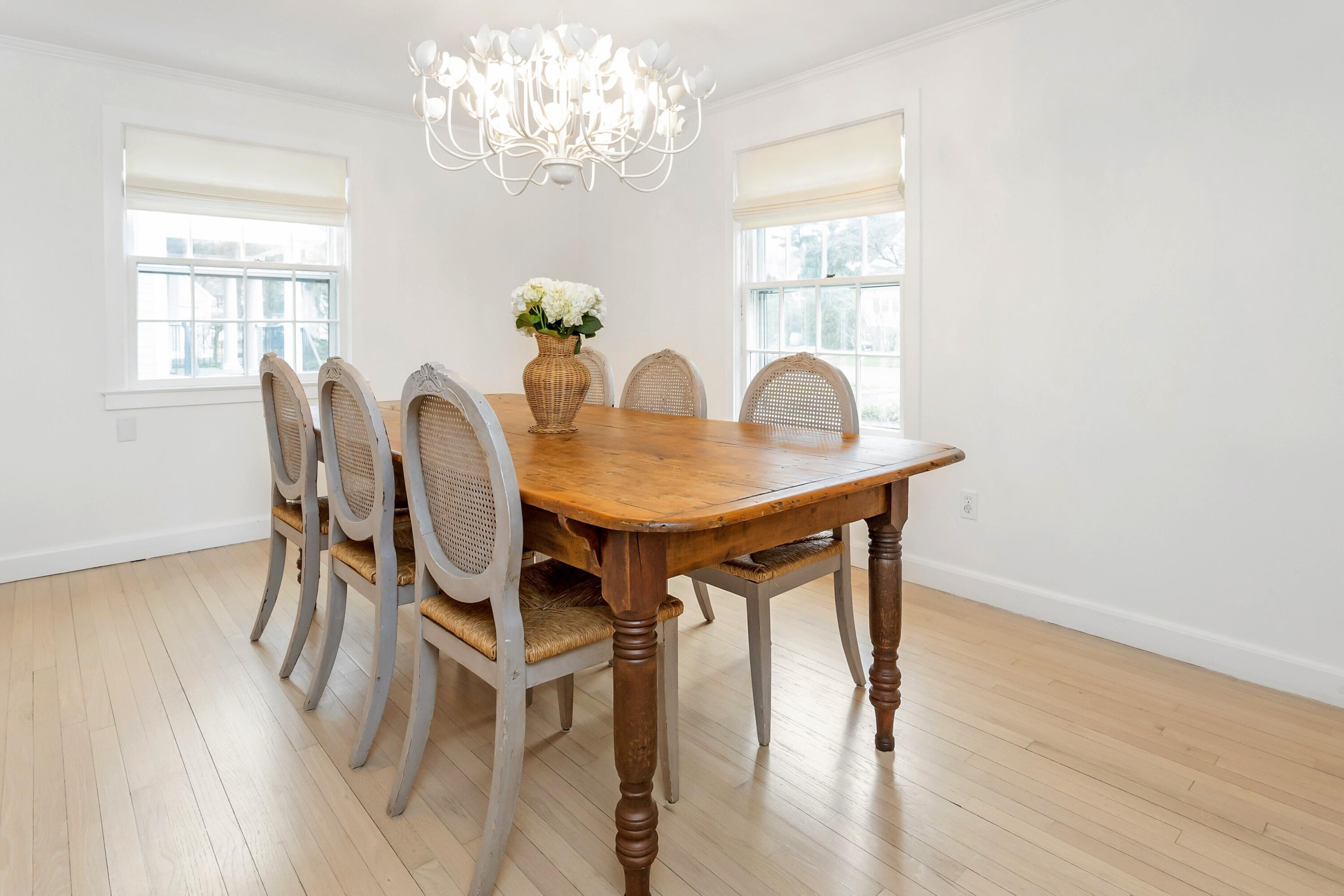 22 Intervale Road Darien, CT 06820 - Photo 11 of 37 a dining room with furniture a chandelier and wooden floor