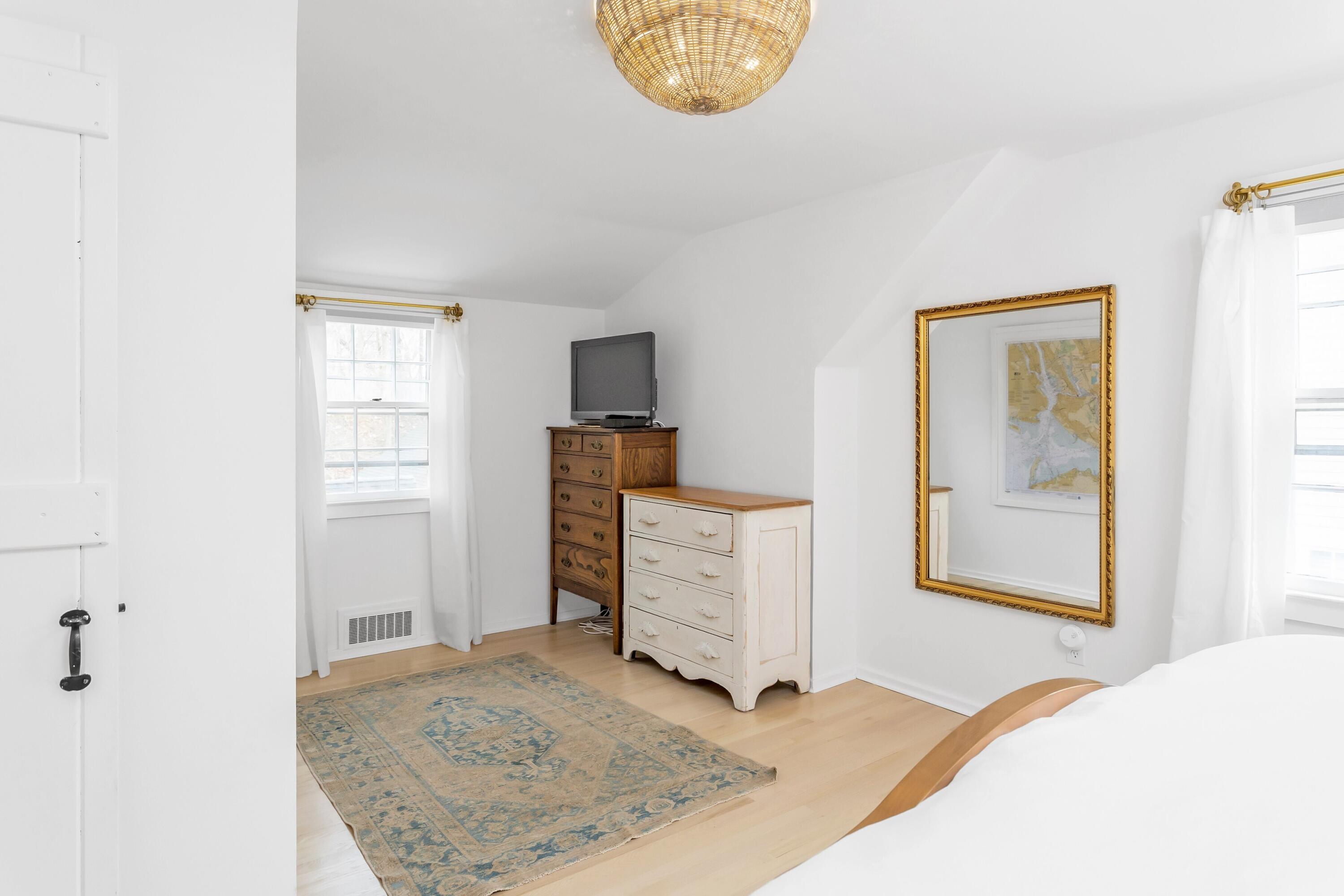 22 Intervale Road Darien, CT 06820 - Photo 19 of 37 a bedroom with a bed and a dresser in it