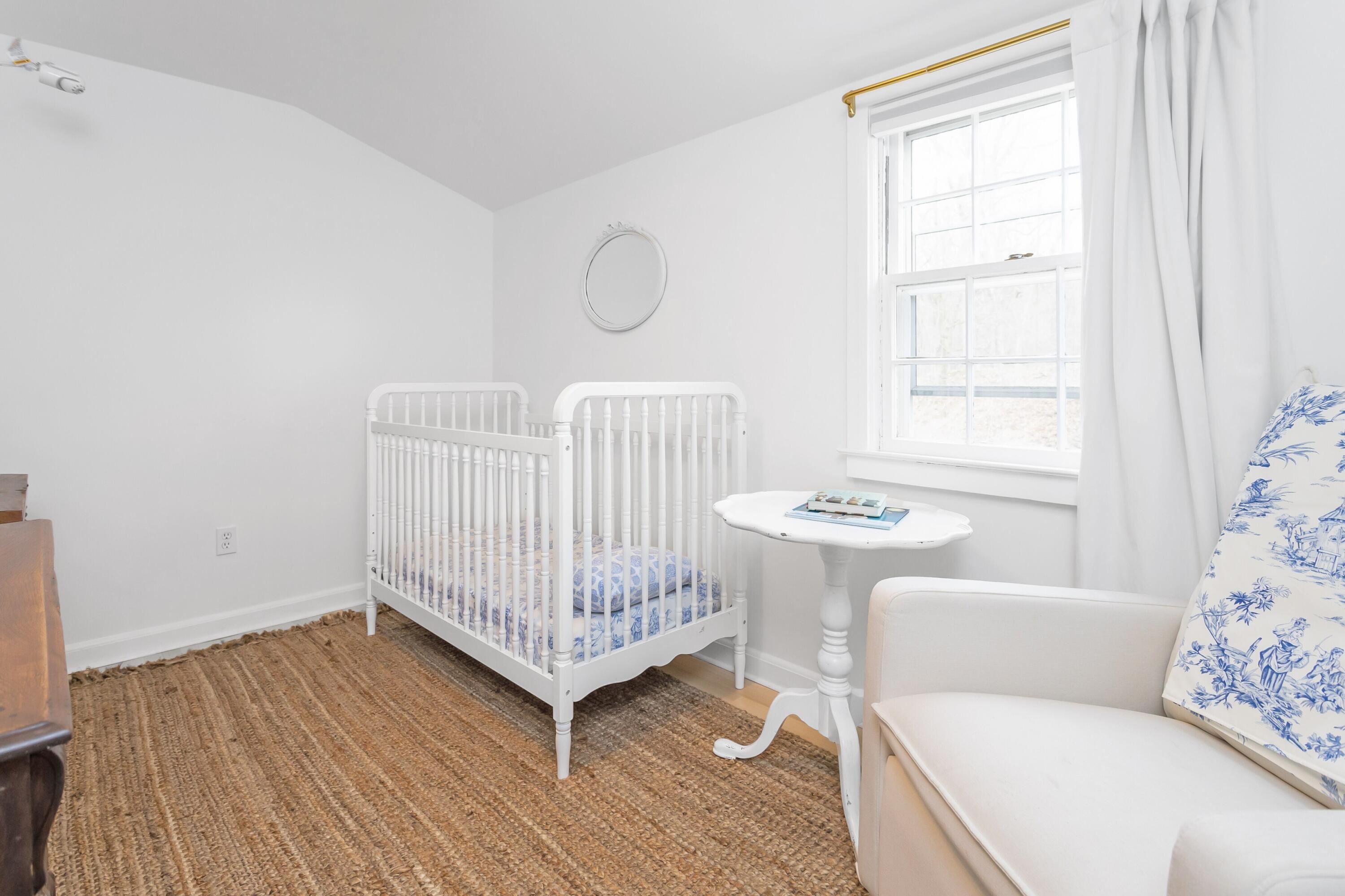 22 Intervale Road Darien, CT 06820 - Photo 20 of 37 a living room with a baby crib furniture and a window