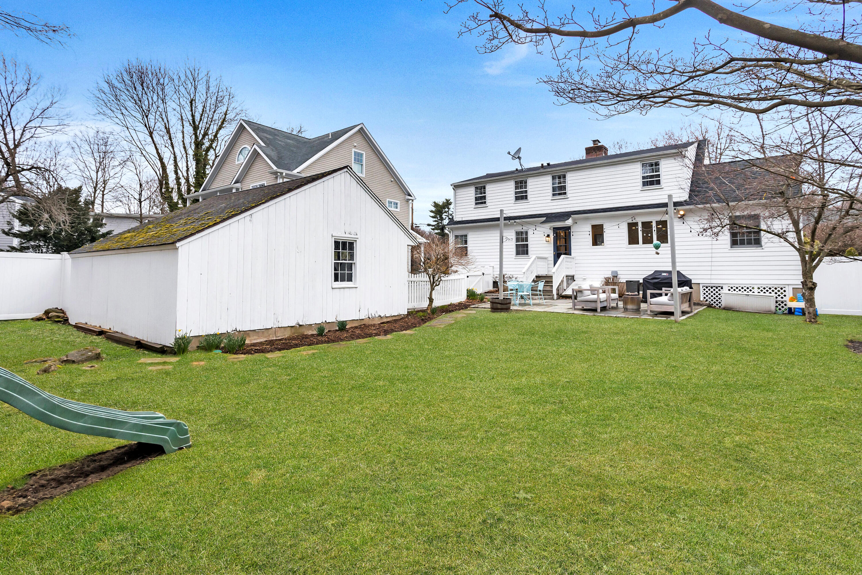 22 Intervale Road Darien, CT 06820 - Photo 31 of 37 a view of a house with a yard and sitting area