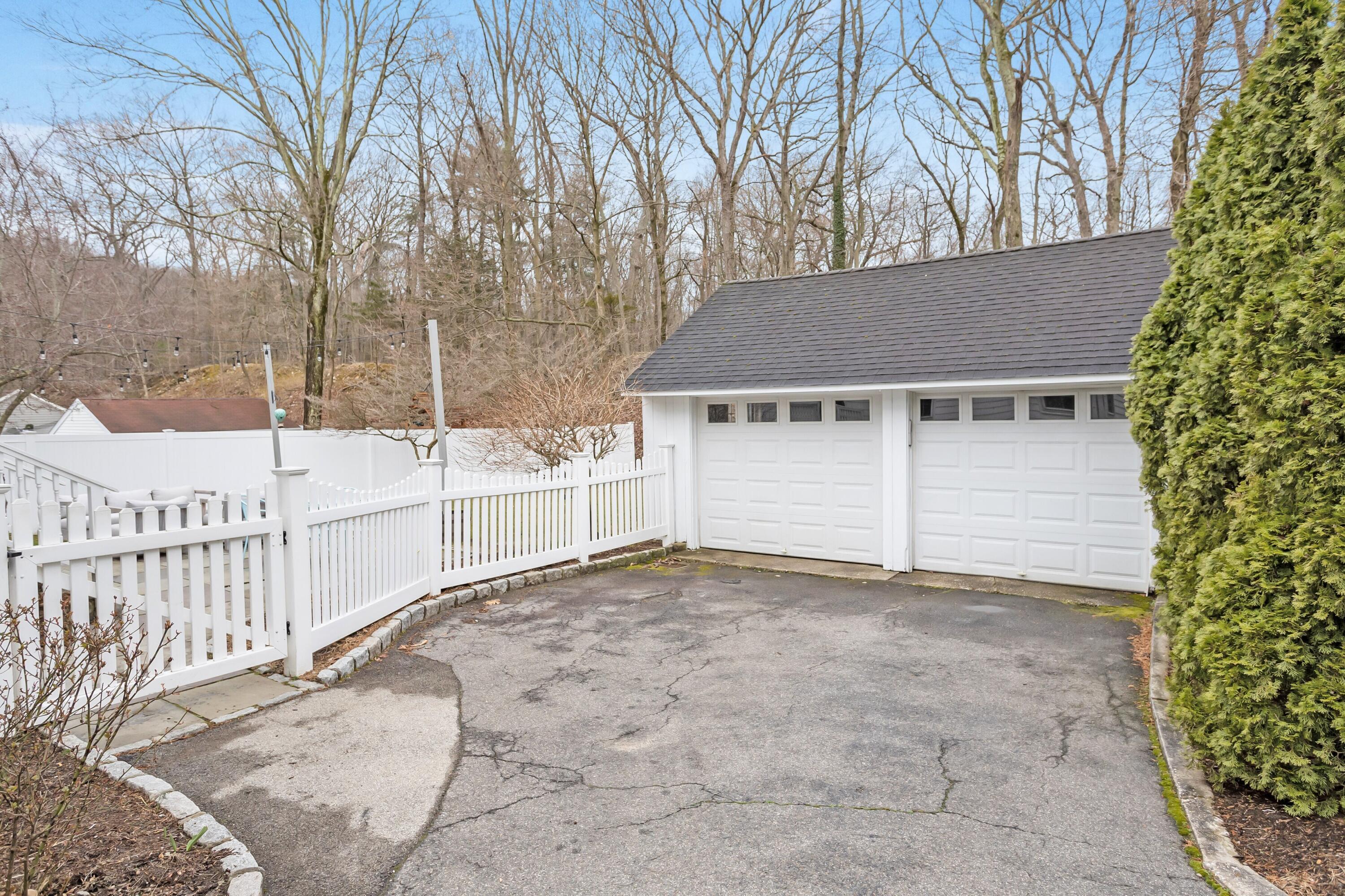 22 Intervale Road Darien, CT 06820 - Photo 33 of 37 a view of a house with a large tree and wooden fence
