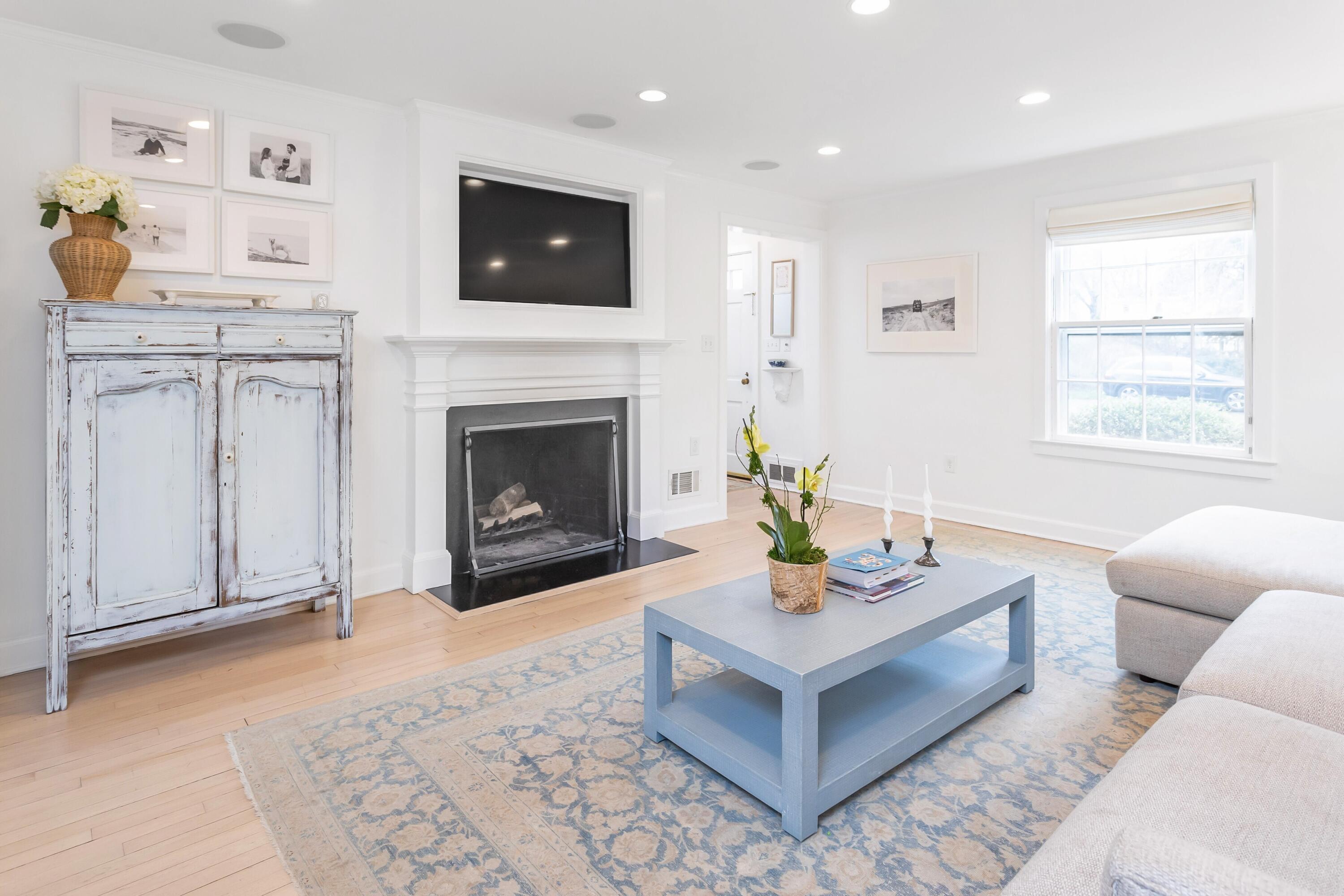 22 Intervale Road Darien, CT 06820 - Photo 5 of 37 a living room with furniture a flat screen tv and a fireplace
