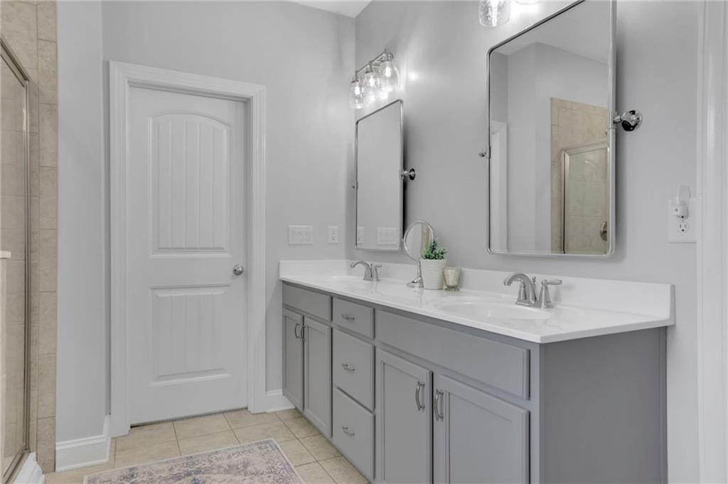6255 Allison Road Cumming, GA 30040 - Photo 20 of 36 a bathroom with a double vanity sink and a mirror