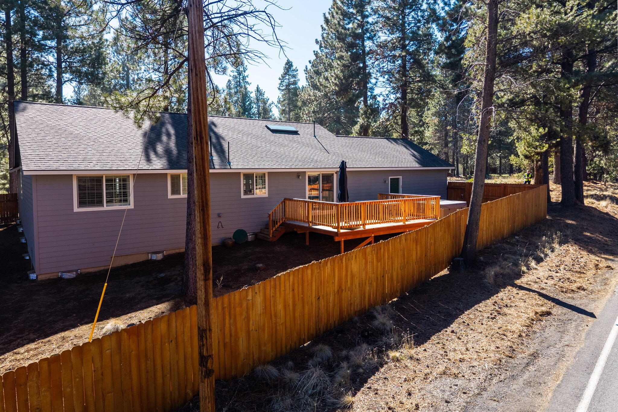 17064 Sacramento Road Bend, OR 97707 - Photo 40 of 50 a view of a house with wooden fence and a tree
