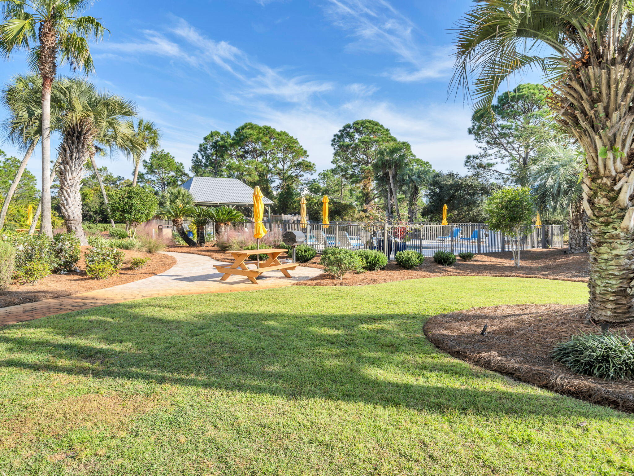 145 Beachfront Trail, Unit 307A Santa Rosa Beach, FL 32459 - Photo 38 of 60 a view of swimming pool with lawn chairs and palm trees