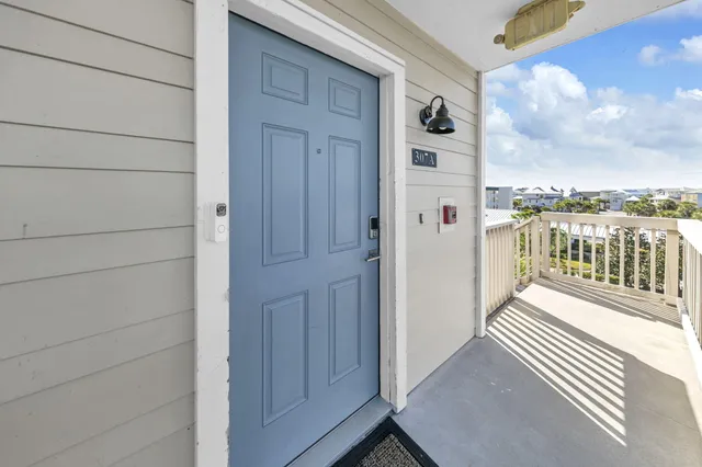 a bathroom with a granite countertop sink mirror vanity and toilet