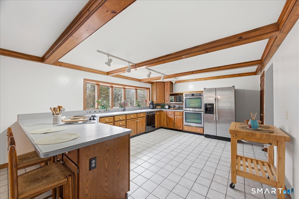 21 4 Mile River Road Old Lyme, CT 06371 - Photo 12 of 40 a kitchen with a sink and chairs