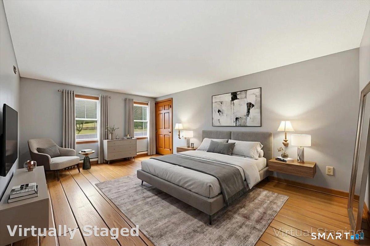 21 4 Mile River Road Old Lyme, CT 06371 - Photo 16 of 40 a bedroom with a large bed couch and a window