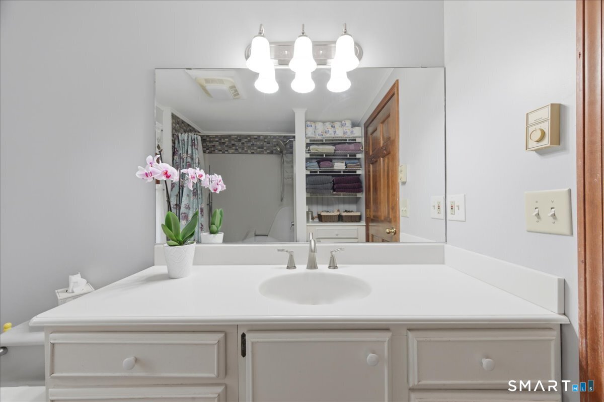 21 4 Mile River Road Old Lyme, CT 06371 - Photo 17 of 40 a bathroom with a sink and a mirror