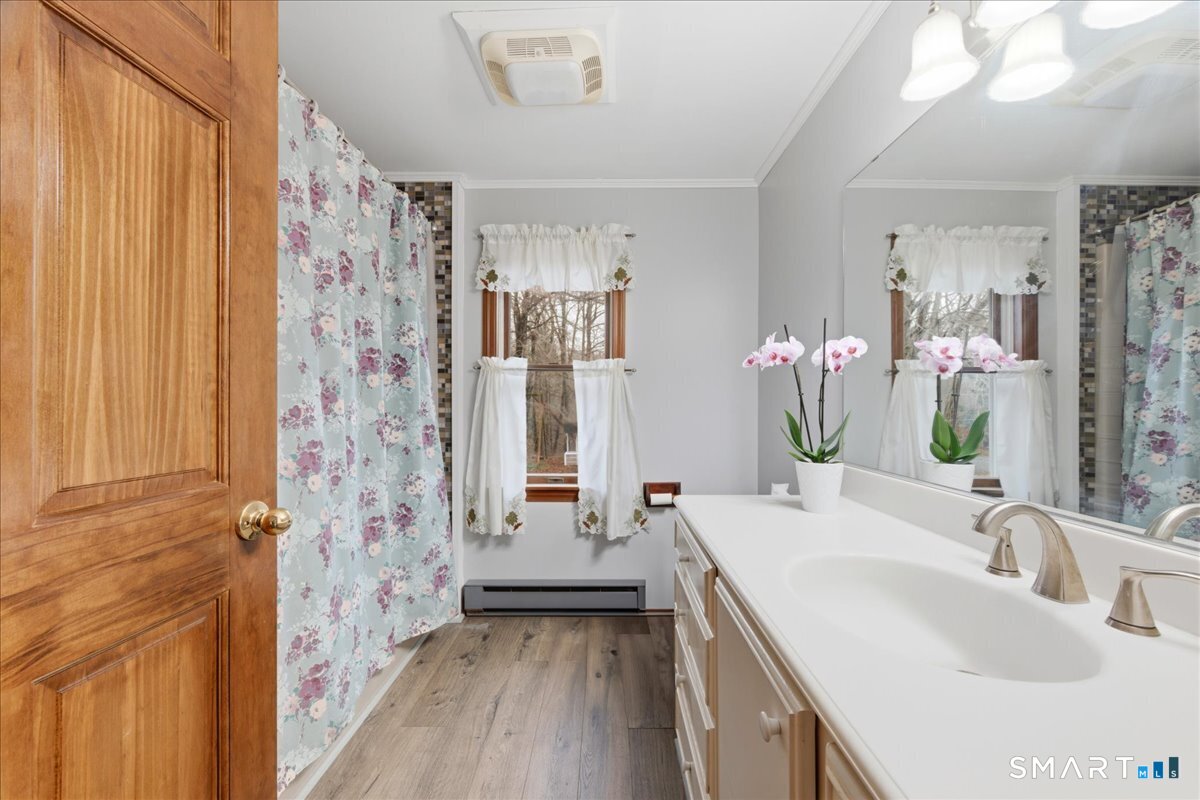 21 4 Mile River Road Old Lyme, CT 06371 - Photo 18 of 40 a bathroom with a sink a vanity and a mirror