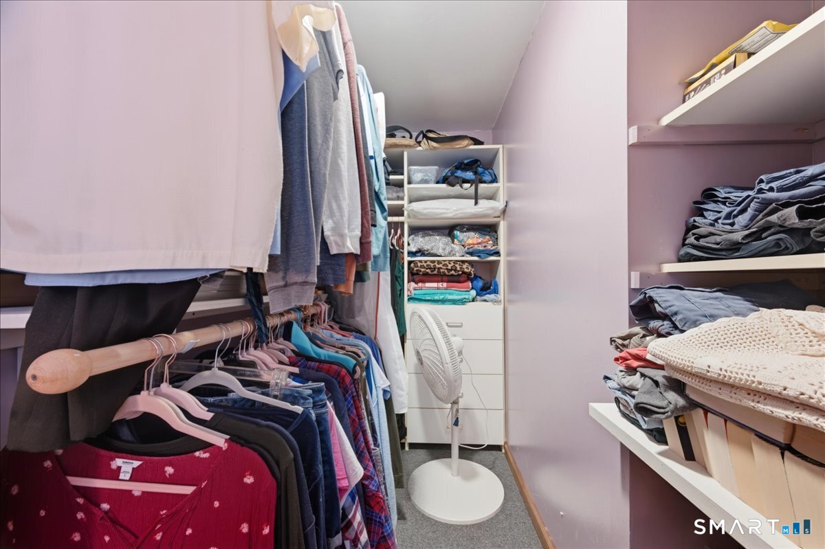 21 4 Mile River Road Old Lyme, CT 06371 - Photo 19 of 40 a view of walk in closet with clothes and shoes