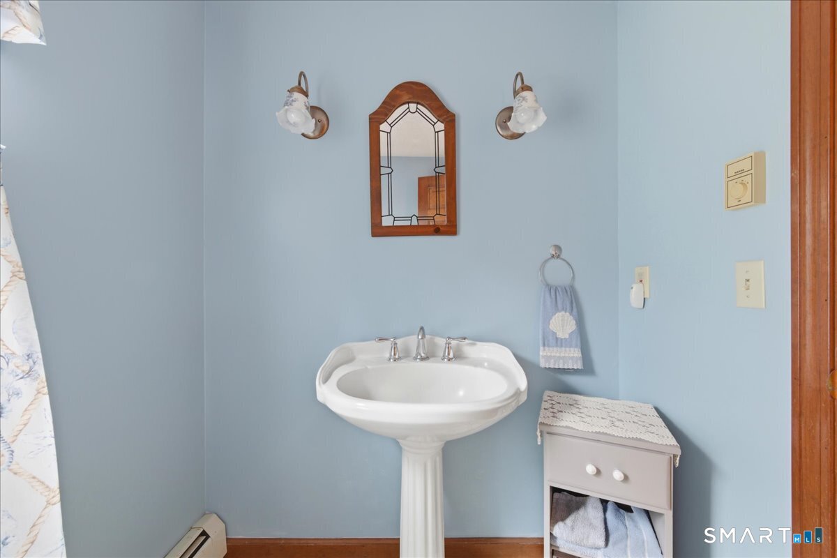 21 4 Mile River Road Old Lyme, CT 06371 - Photo 20 of 40 a bathroom with a sink and a mirror