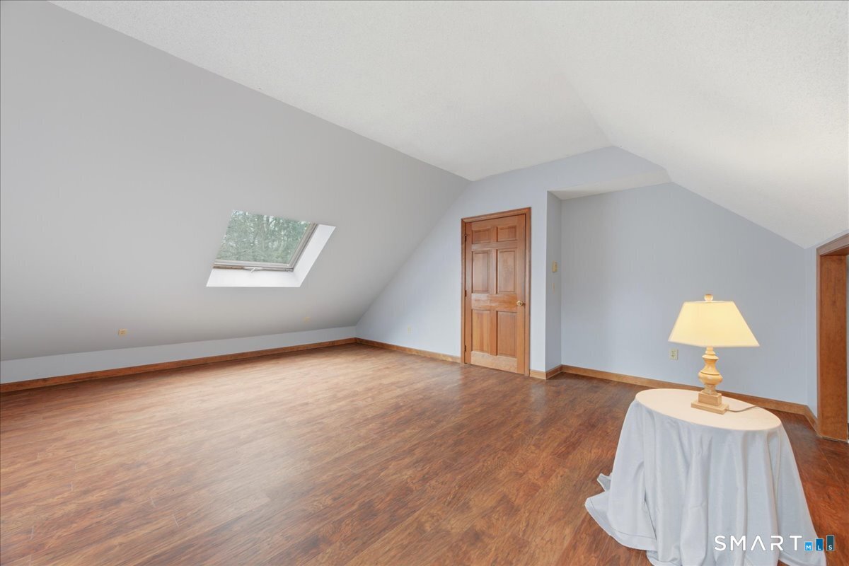 21 4 Mile River Road Old Lyme, CT 06371 - Photo 27 of 40 a view of an empty room and wooden floor