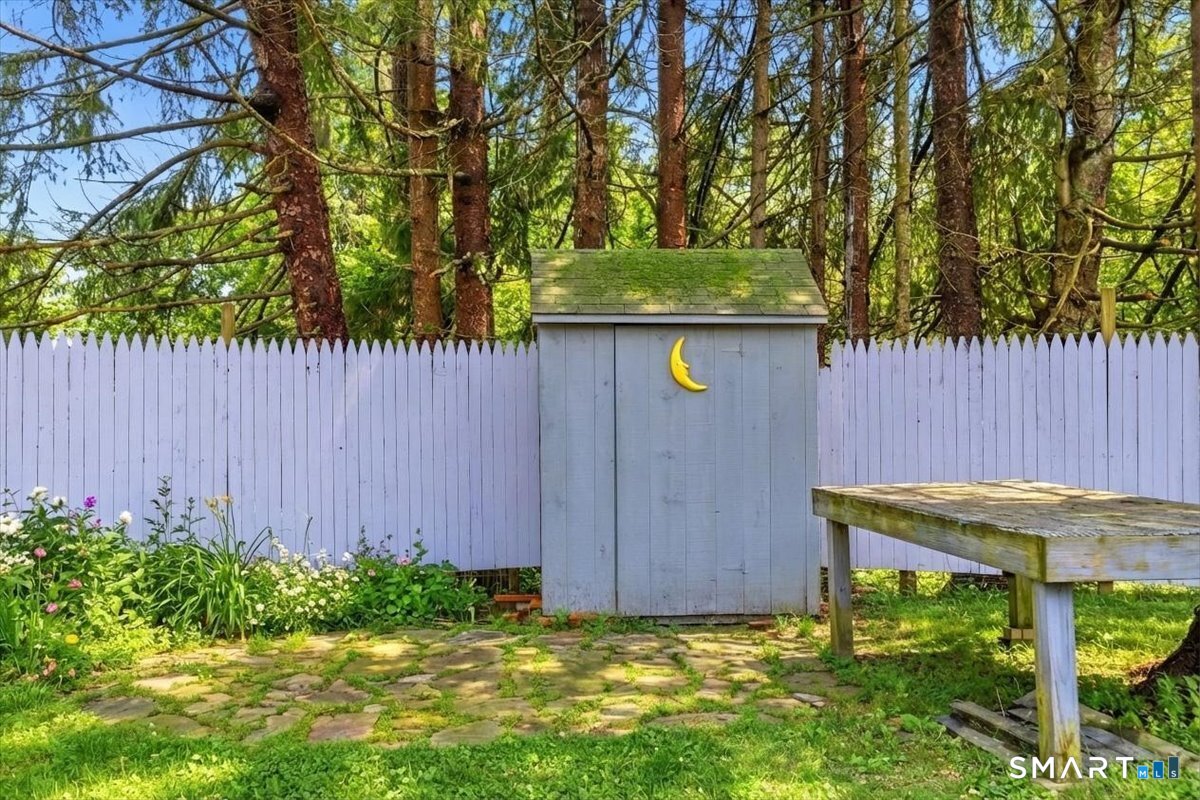21 4 Mile River Road Old Lyme, CT 06371 - Photo 38 of 40 a view of a backyard with a small cabin and a chair