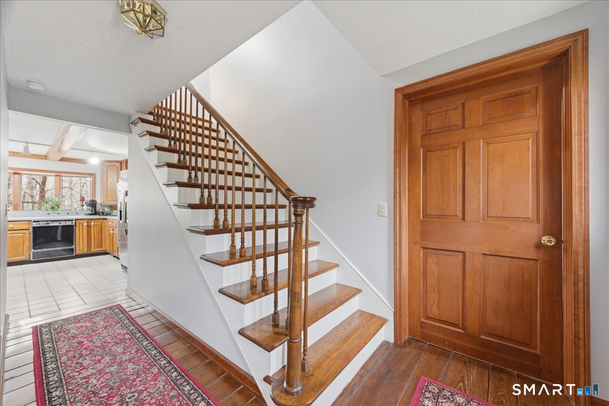 21 4 Mile River Road Old Lyme, CT 06371 - Photo 5 of 40 a view of entryway and hall with wooden floor