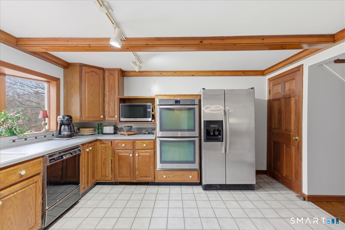 21 4 Mile River Road Old Lyme, CT 06371 - Photo 9 of 40 a kitchen with stainless steel appliances granite countertop a refrigerator and a sink