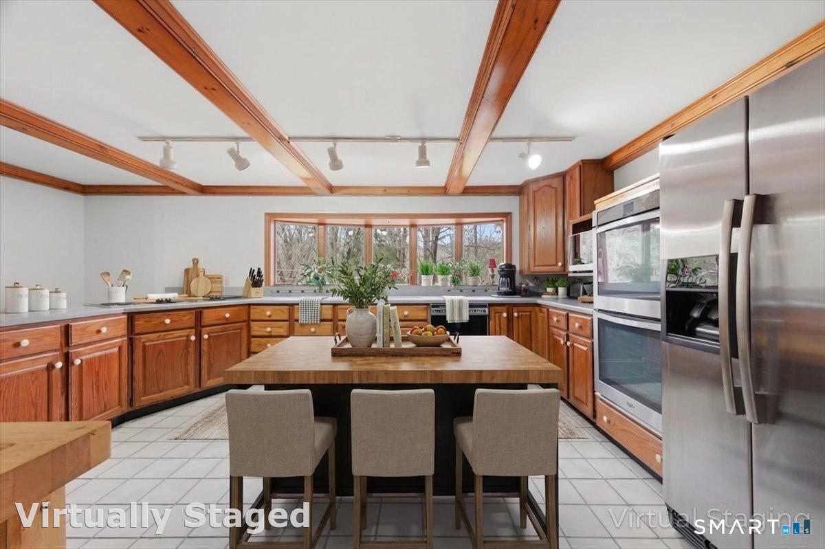 21 4 Mile River Road Old Lyme, CT 06371 - Photo 10 of 40 a kitchen with granite countertop a table chairs stove and refrigerator