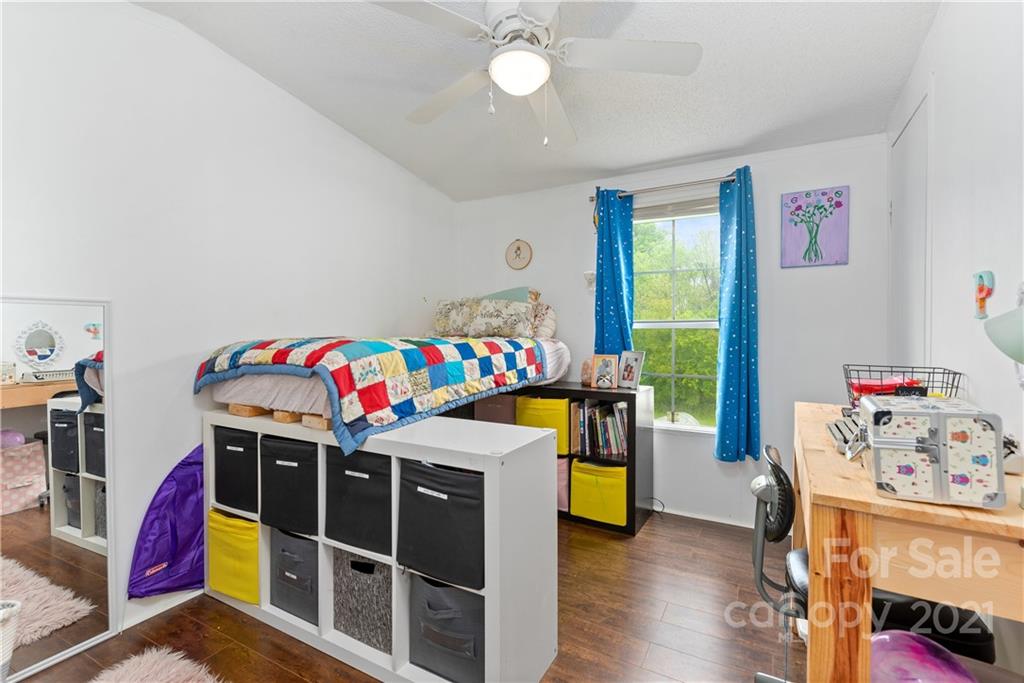 3 Buckner Road Leicester, NC 28748 - Photo 17 of 28 a bedroom with a bed and a baby crib