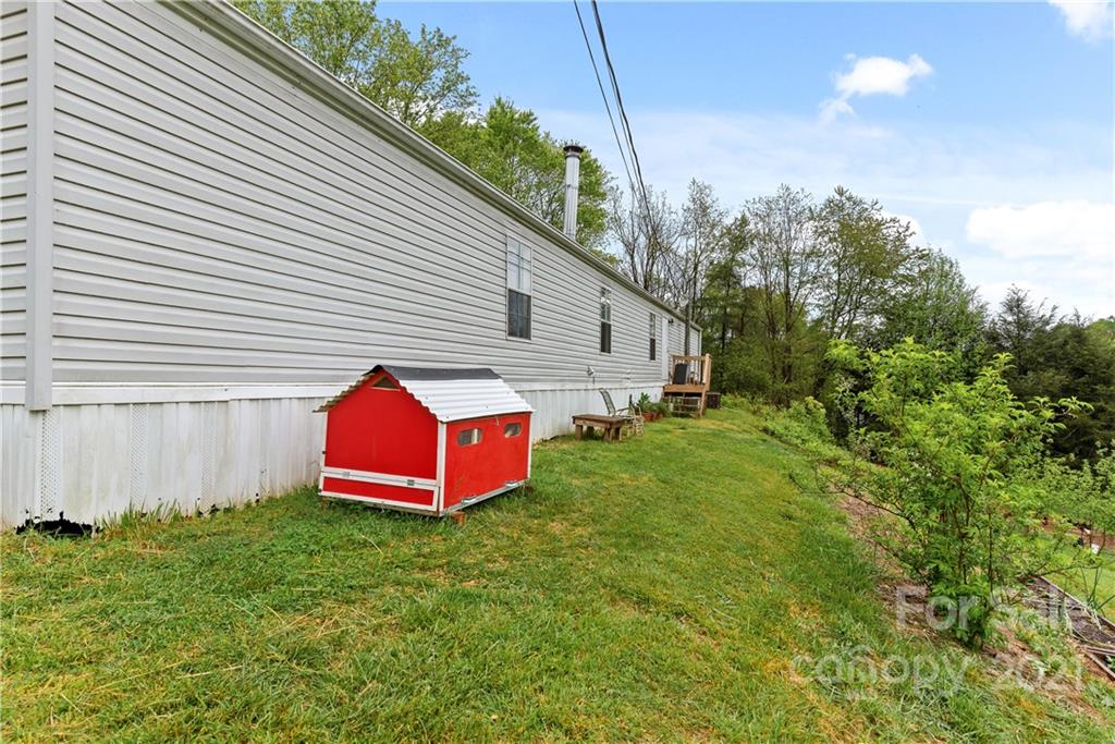 3 Buckner Road Leicester, NC 28748 - Photo 24 of 28 a view of a backyard with plants and a garden