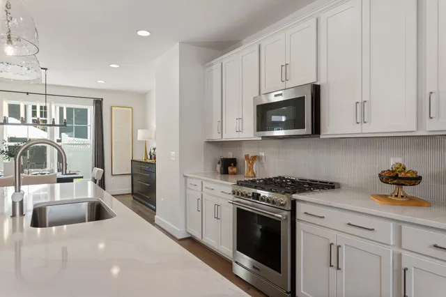 a kitchen with appliances a sink and cabinets