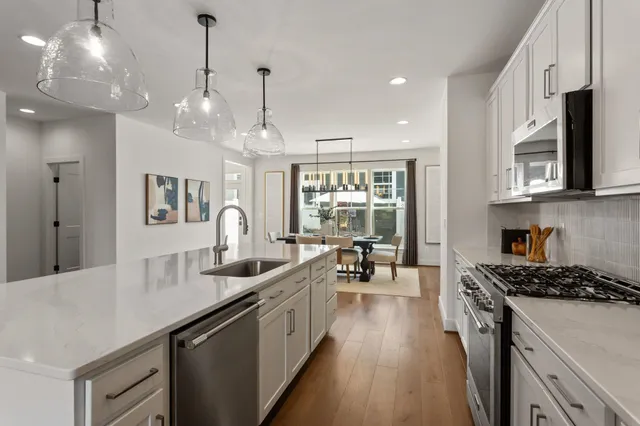 a stove top oven sitting inside of a kitchen