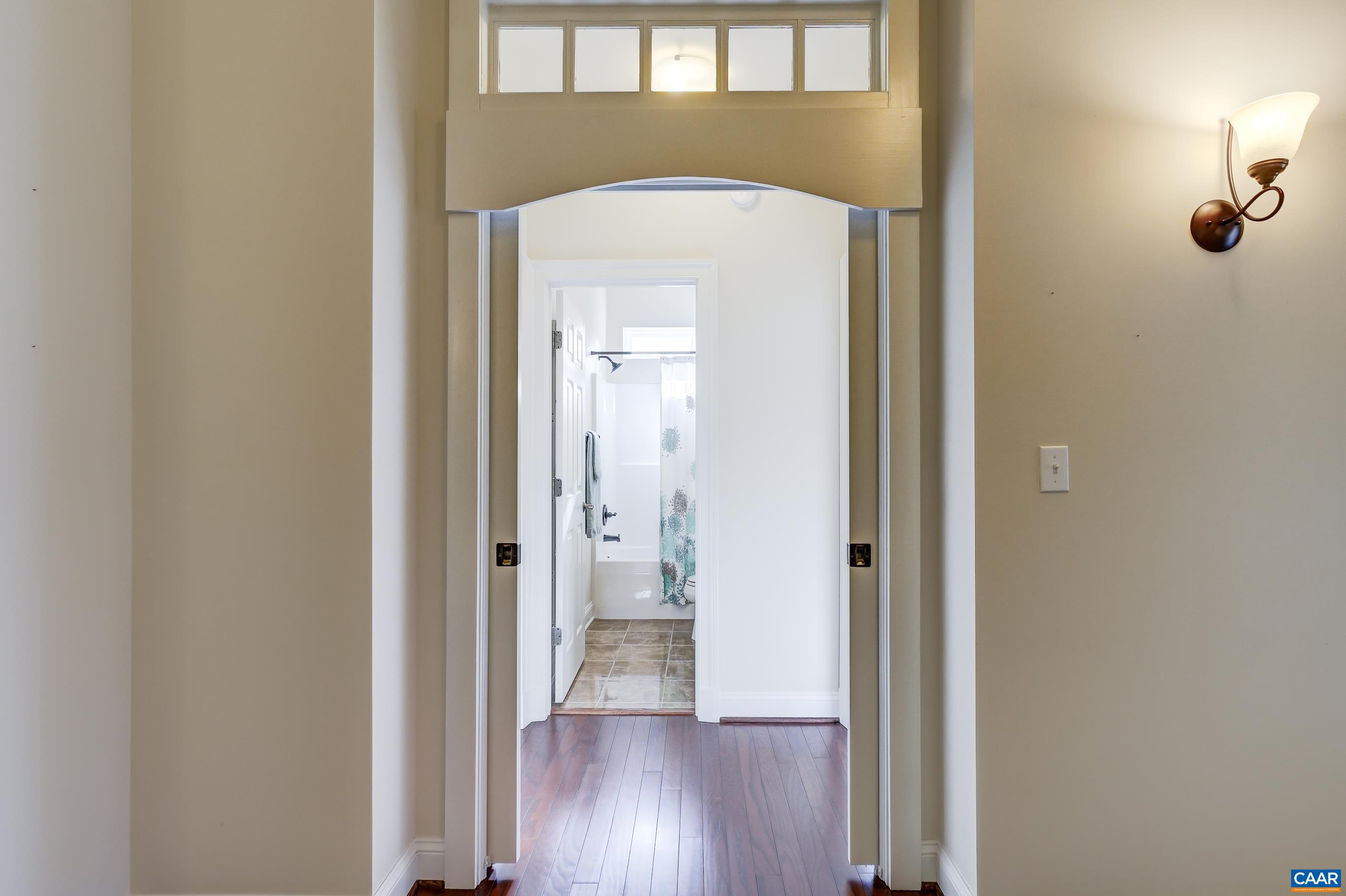 4634 Mechums River Road Charlottesville, VA 22901 - Photo 31 of 59 Pocket doors lead to two main level bedrooms and full bathroom- providing privacy for guests.
