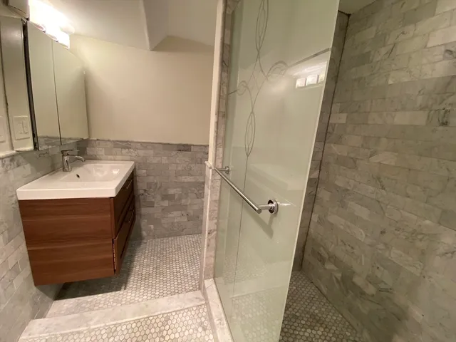 a bathroom with a sink a mirror and shower
