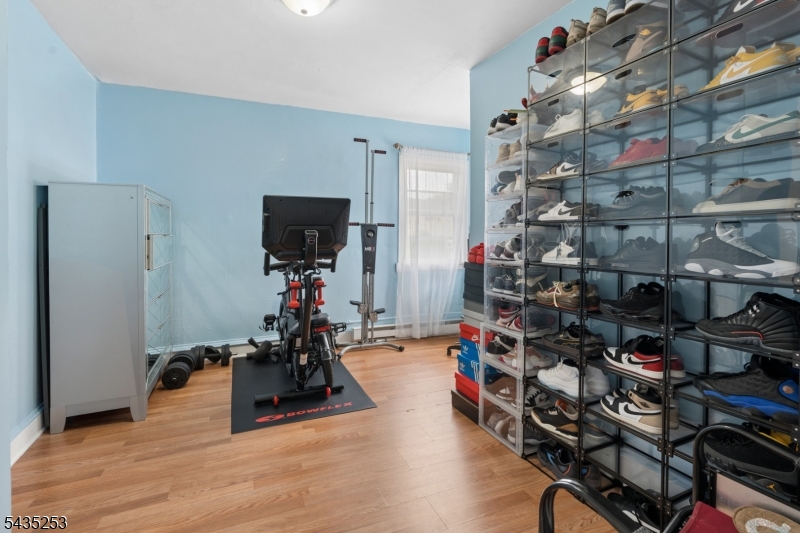 61 Union Street, Unit 2 Lodi, NJ 07644 - Photo 4 of 8 a room with lots of wooden furniture and a book shelf