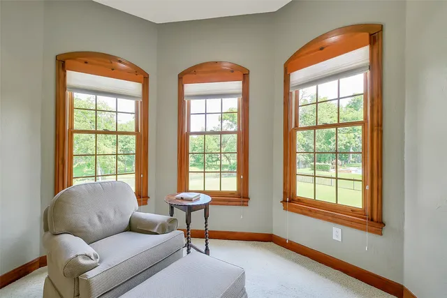 a living room with furniture and a floor to ceiling window