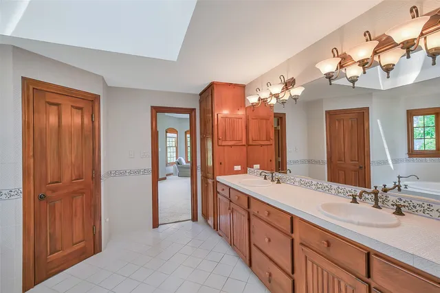 a white bath tub sitting next to a shower