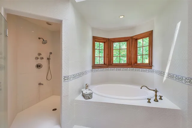 a bedroom with a bed dresser and a window