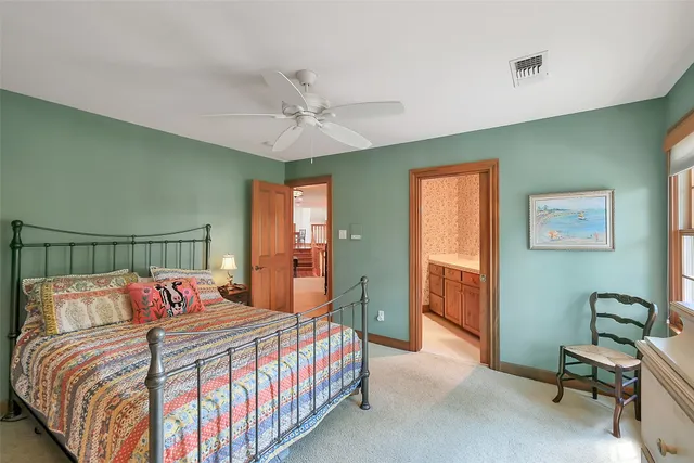 a living room with furniture a rug and a bookshelf