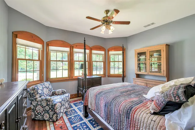 a bedroom with a bed and a dresser in it