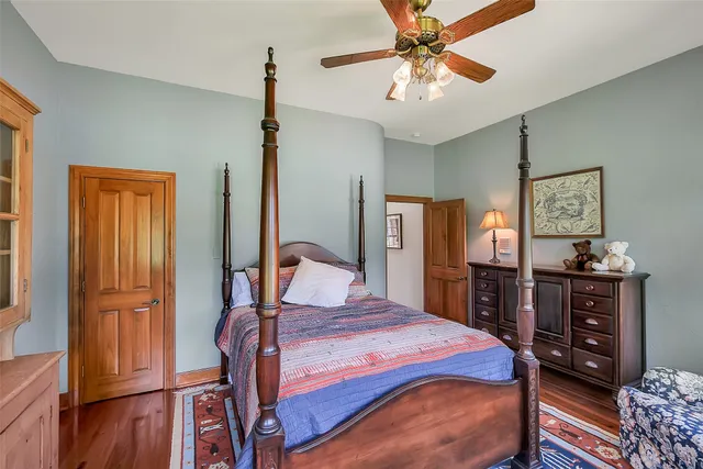 a bathroom with a granite countertop sink a mirror and shower