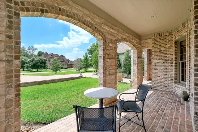a view of a patio with table and chairs and a barbeque