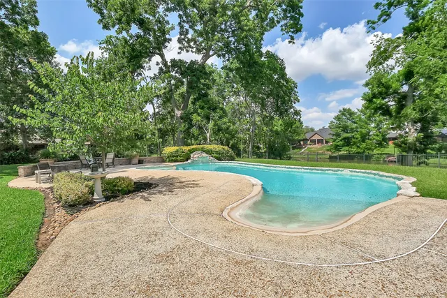 a view of a house with swimming pool and yard