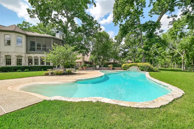 a view of a swimming pool with an outdoor seating and a yard